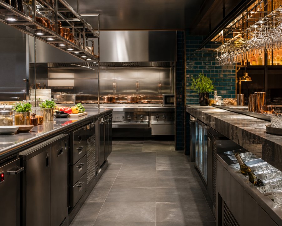 Hotel back-of-house kitchen fitted with stainless steel cooking equipment